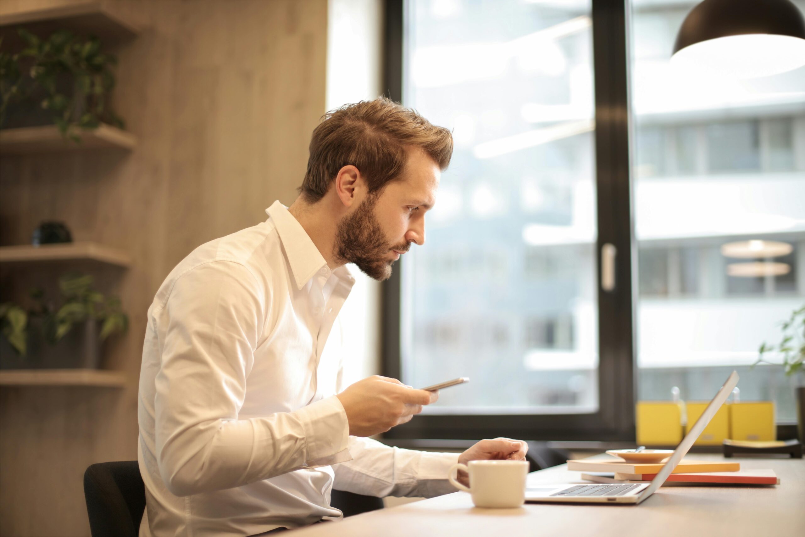 a man with a beard sitting at a desk with his foreign company in Thailand