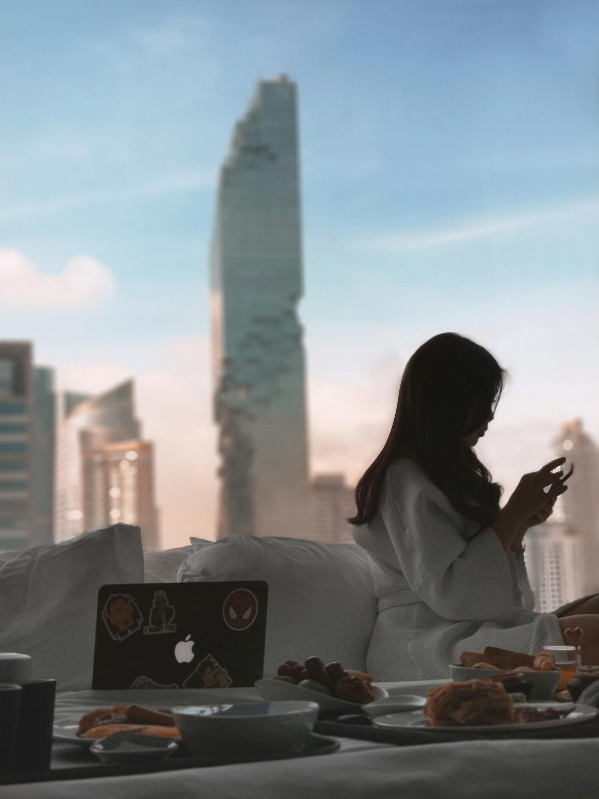 A woman working in front of Mahanakon Tower in Bangkok on a dtv visa