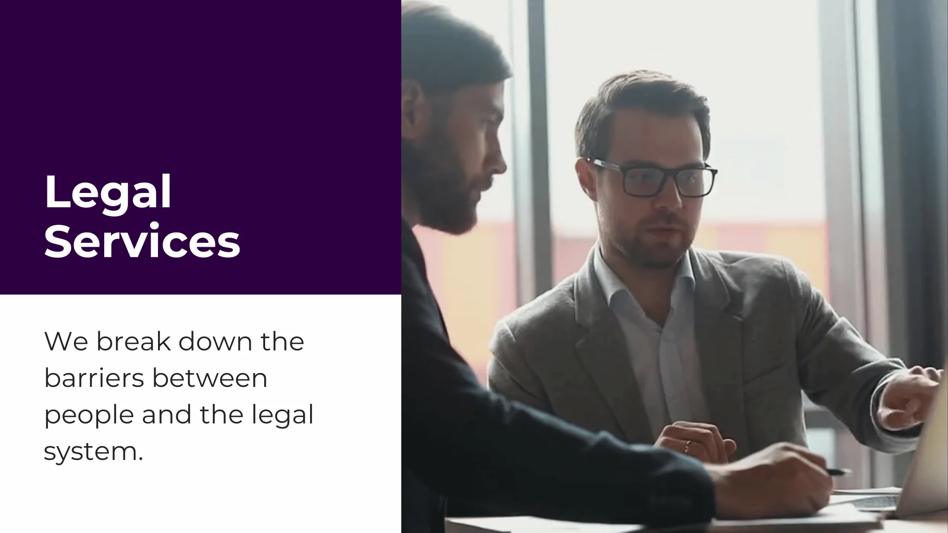 two people sitting at a computer discussing legal services