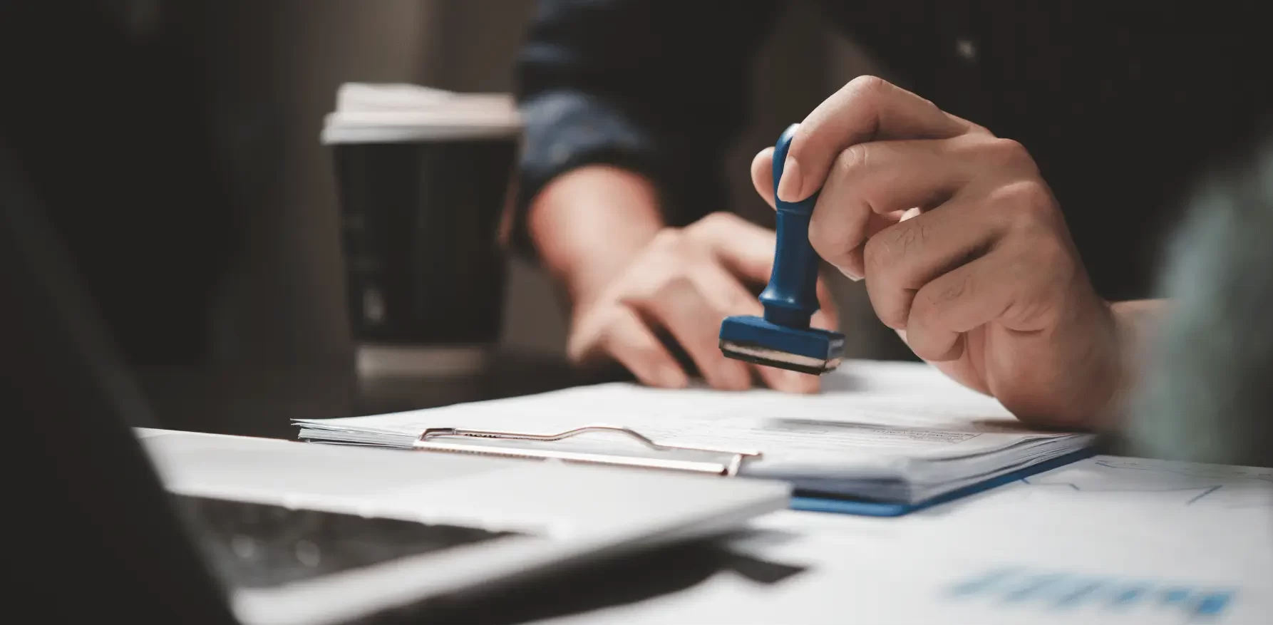 a sponsored visa and work permit header image showing a man at immigration stamping a visa