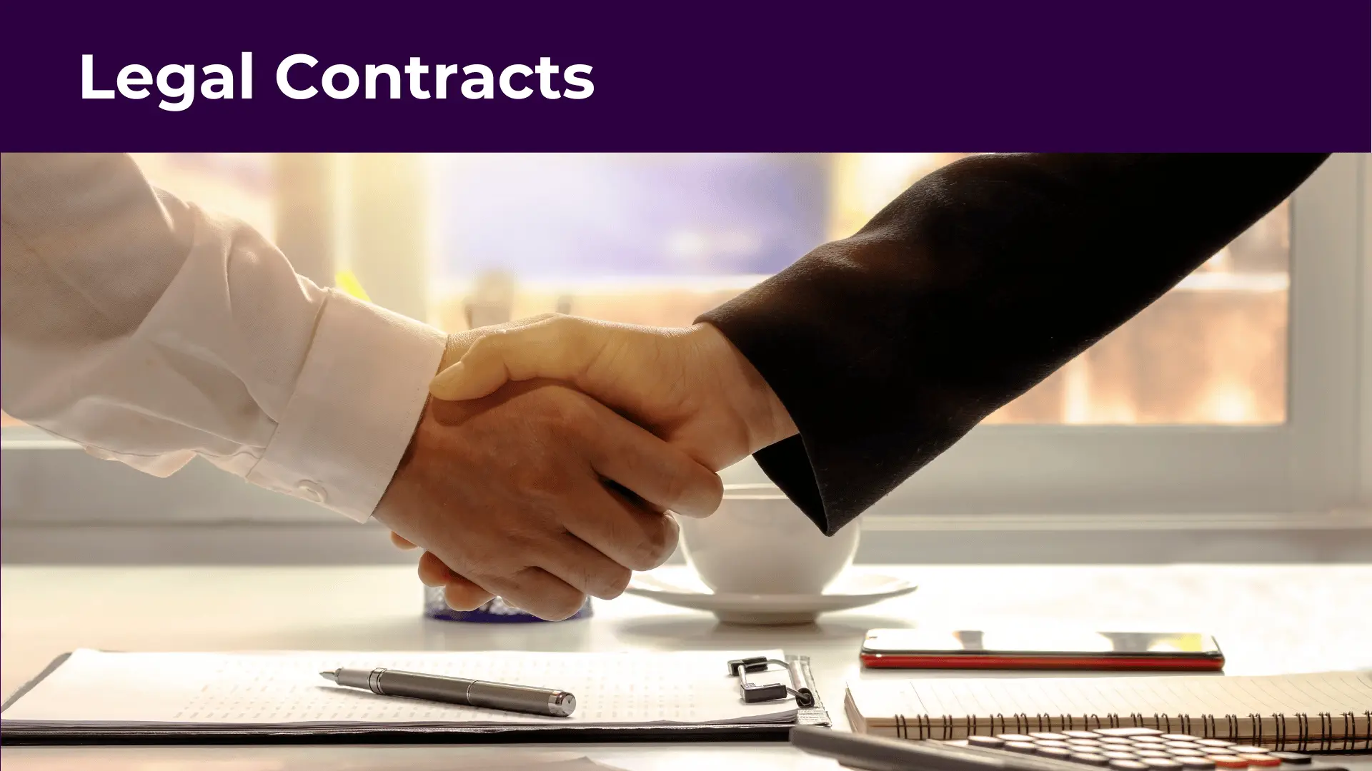 two people shaking hands over a legal contract