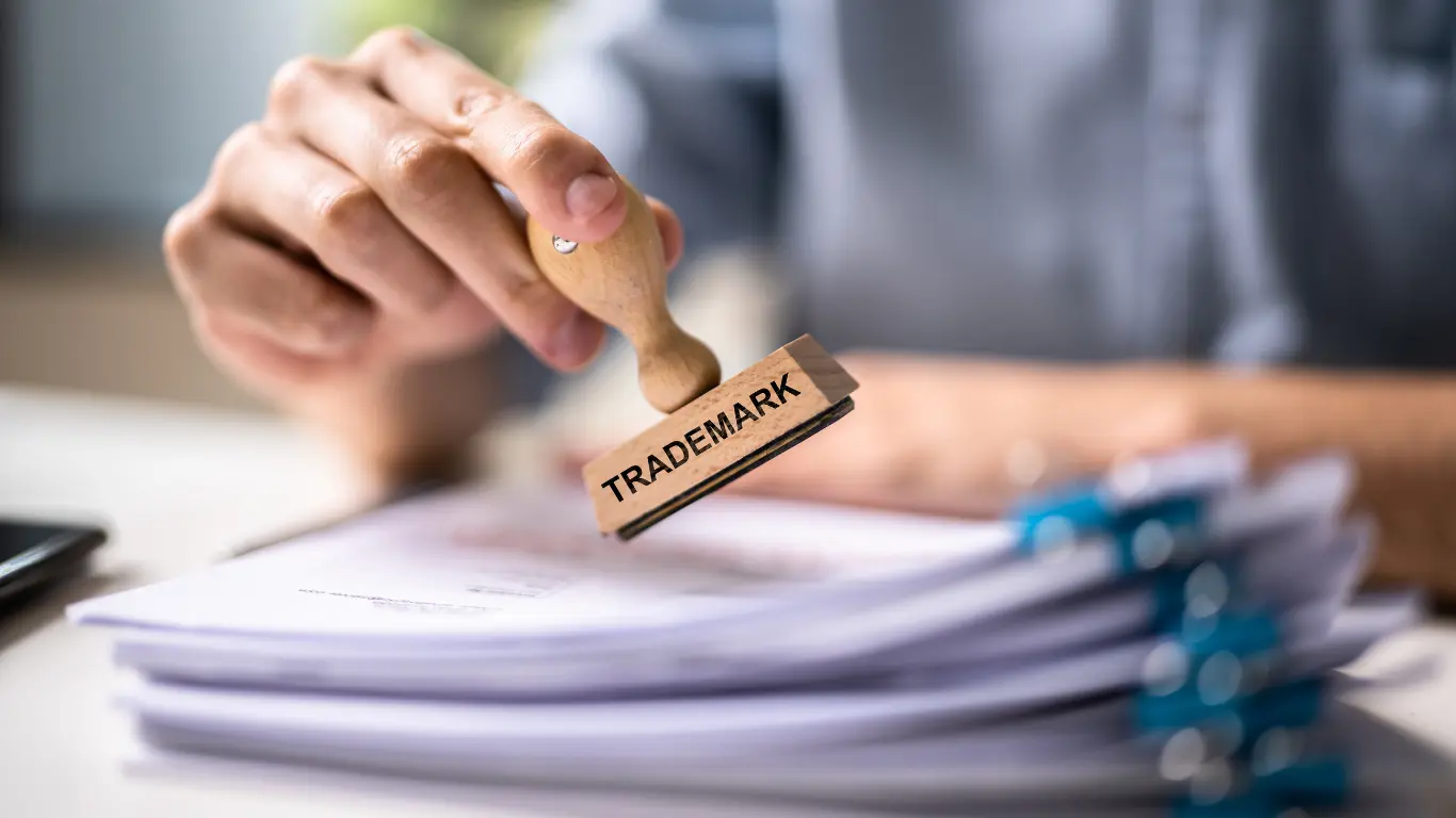 a hand of a man stamping a trademark registration in thailand