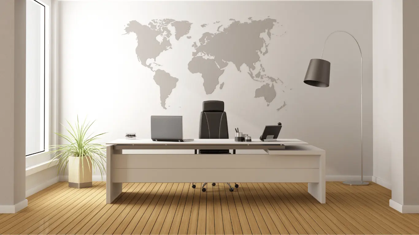 an empty chai and desk in front of a world map