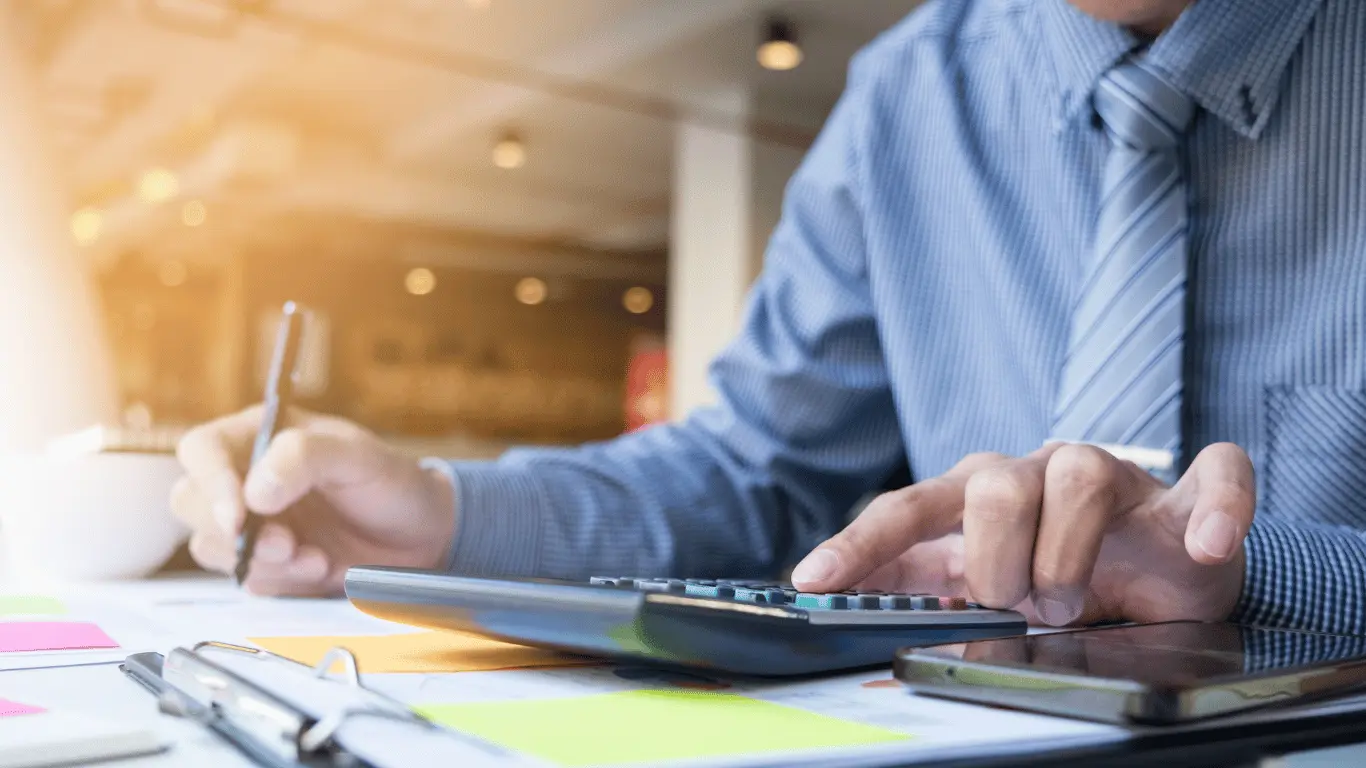 an accountant in thailand filling in forms at a desk