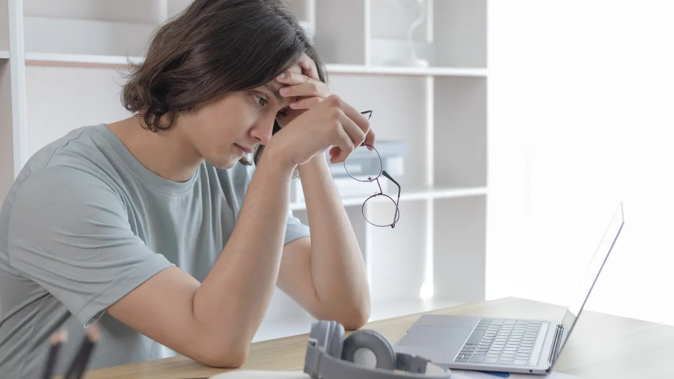 a lady sitting looking at her accounting firms audit of her company, head in hand
